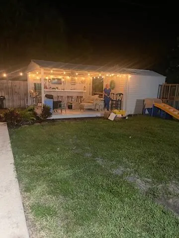 a view of a big yard with table and chairs