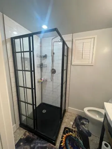 a bathroom with a sink toilet and shower
