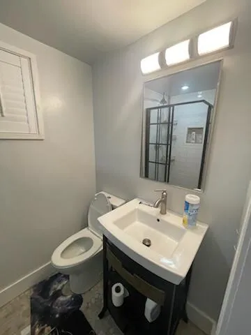 a bathroom with a sink a toilet and a mirror