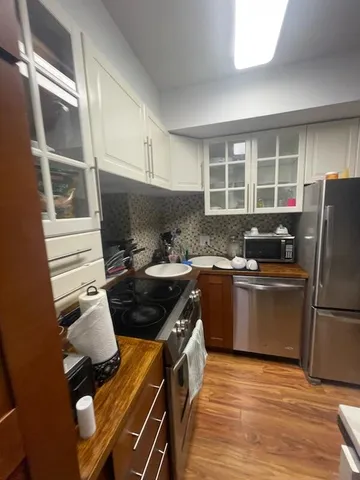 a kitchen with a sink appliances and cabinets
