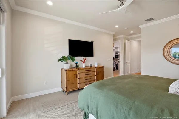 a bedroom with furniture and a flat screen tv