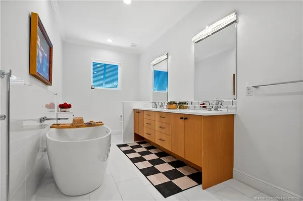 a room with wooden floor and white cabinets