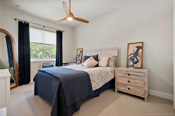 a spacious bedroom with a bed and a window