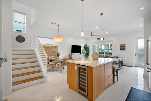 a view of kitchen with kitchen island stainless steel appliances refrigerator stove microwave and furniture
