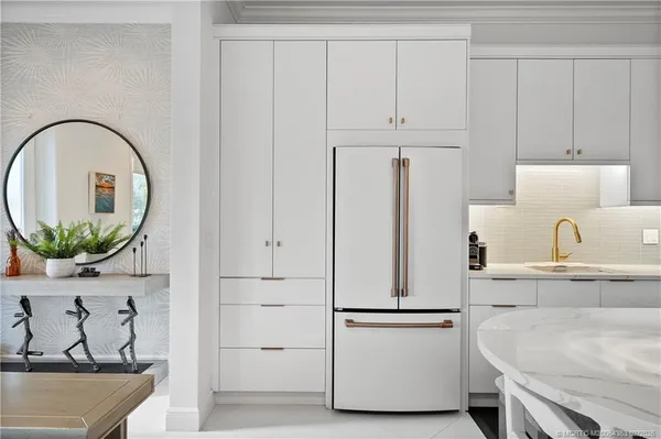 a white refrigerator freezer sitting inside of a kitchen