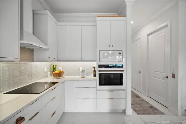 a kitchen with cabinets stainless steel appliances and a sink