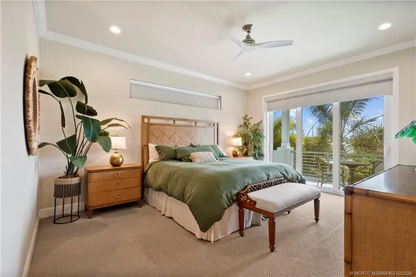 a bedroom with furniture and a large window