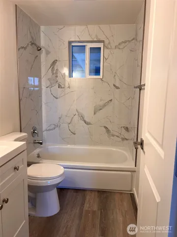 a bathroom with a toilet and a tub