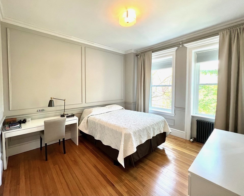 11 Garrison Road, Unit 3 Brookline, MA 02445 - Photo 13 of 23 a bedroom with a bed and a wooden floor