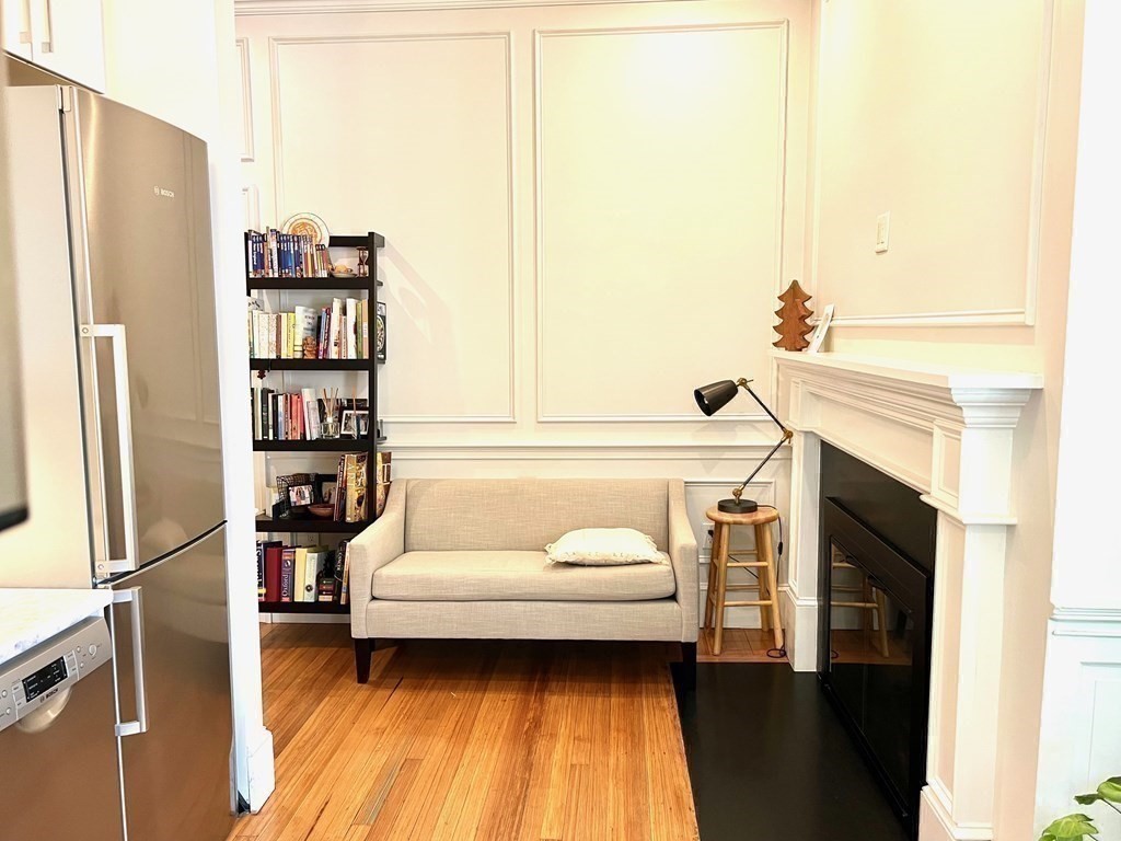 11 Garrison Road, Unit 3 Brookline, MA 02445 - Photo 3 of 23 a living room with a couch and a book shelf