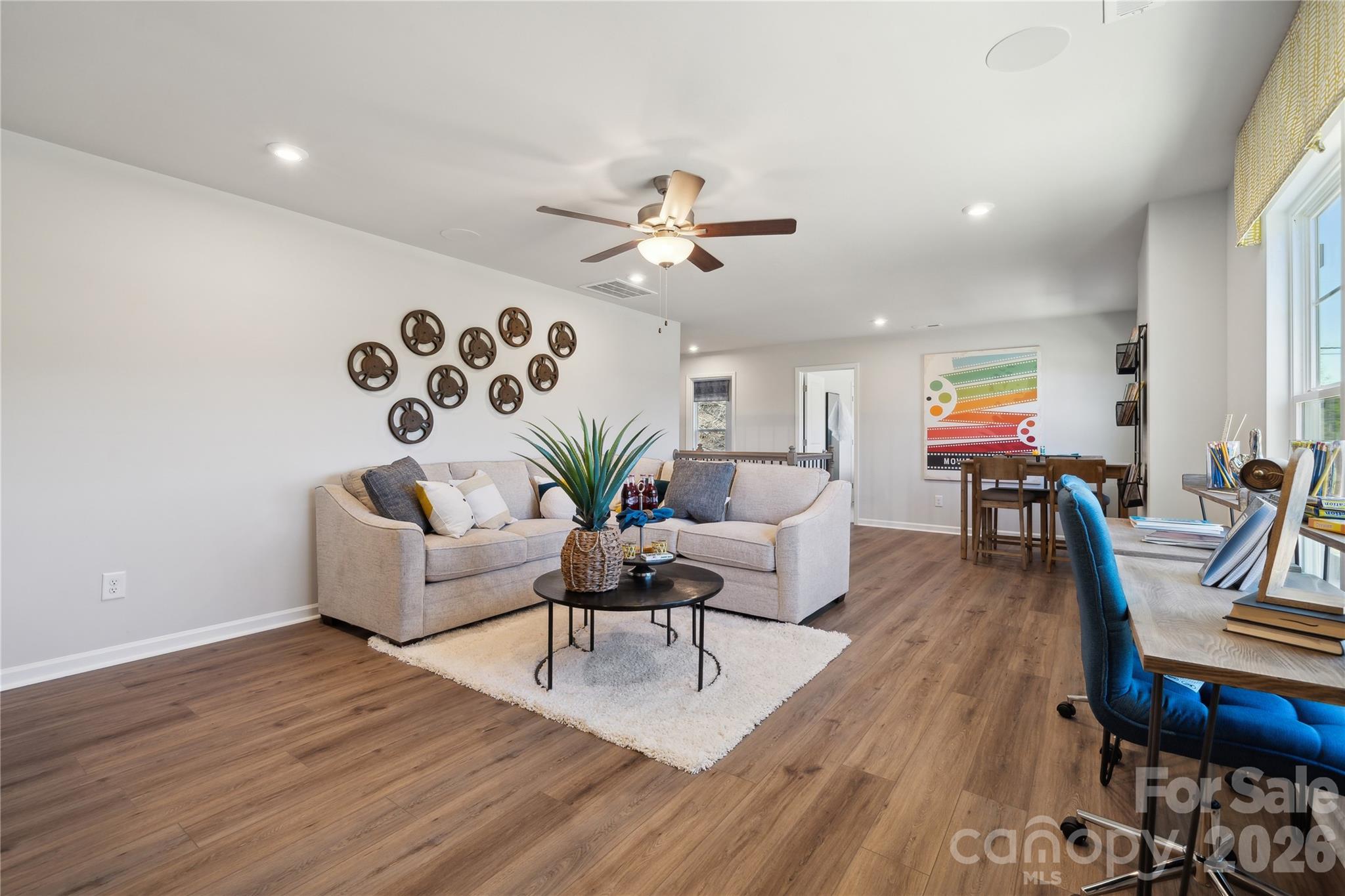 108 Coronado Avenue Matthews, NC 28104 - Photo 15 of 38 a living room with furniture or wooden floor and a chandelier