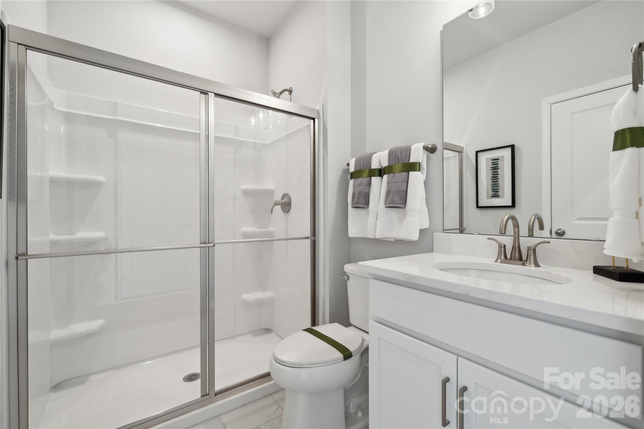 108 Coronado Avenue Matthews, NC 28104 - Photo 19 of 38 a bathroom with a granite countertop sink toilet and shower