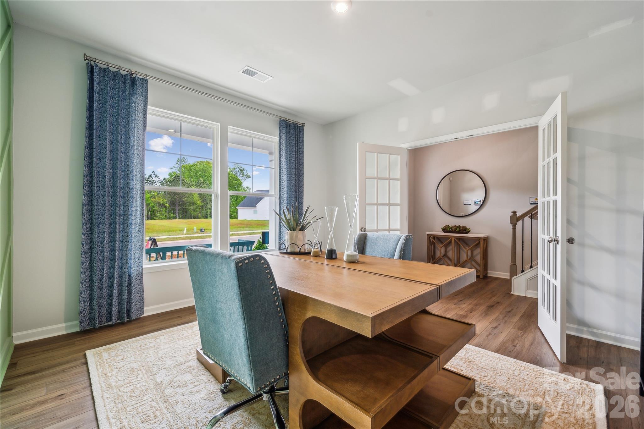 108 Coronado Avenue Matthews, NC 28104 - Photo 26 of 38 a view of a dining room with furniture window and wooden floor