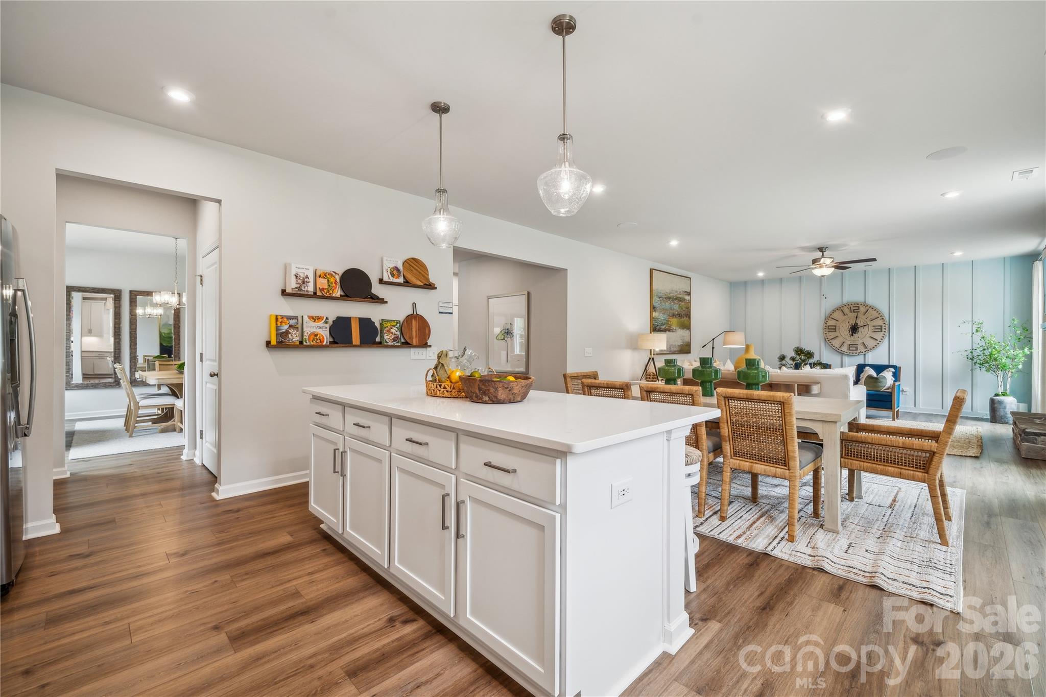 108 Coronado Avenue Matthews, NC 28104 - Photo 9 of 38 a kitchen with stainless steel appliances kitchen island granite countertop a stove a sink a dining table and chairs with wooden floor