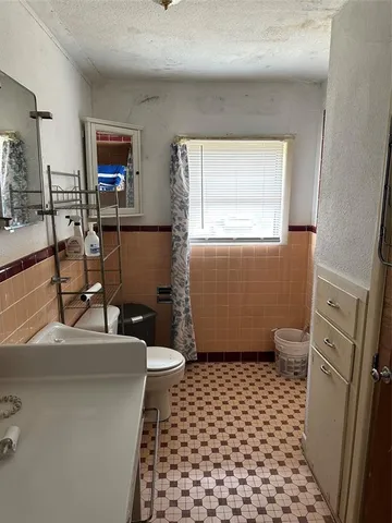 a view of a room with gym equipment and a large window