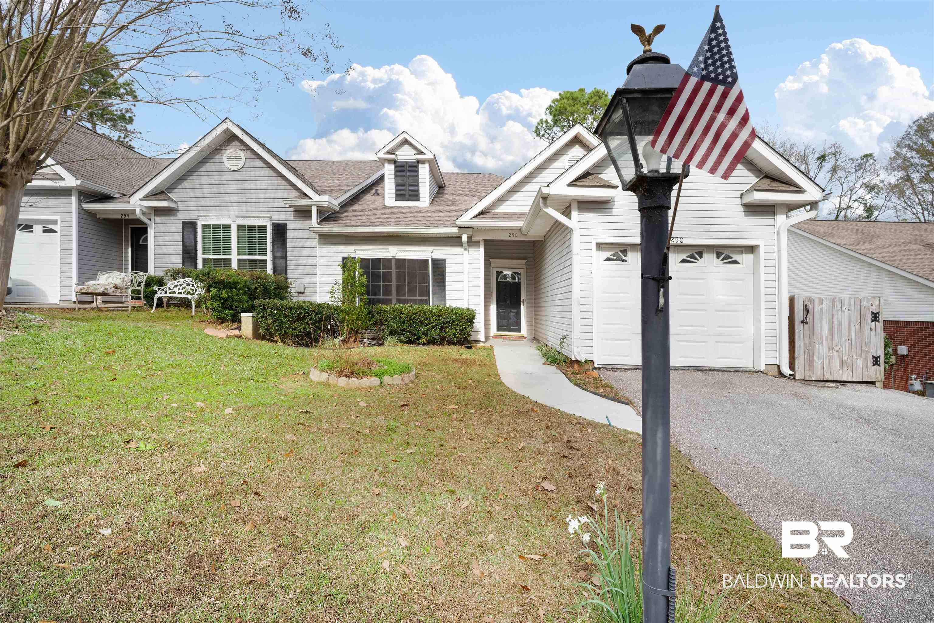 250 North Spring Lake Drive Mobile, AL 36695 - Photo 3 of 29 View of front of house with an attached garage, asphalt driveway, a front lawn, and a shingled roof, extra parking