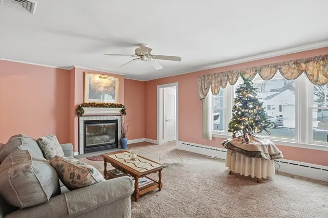 a living room with furniture a chandelier and a fireplace
