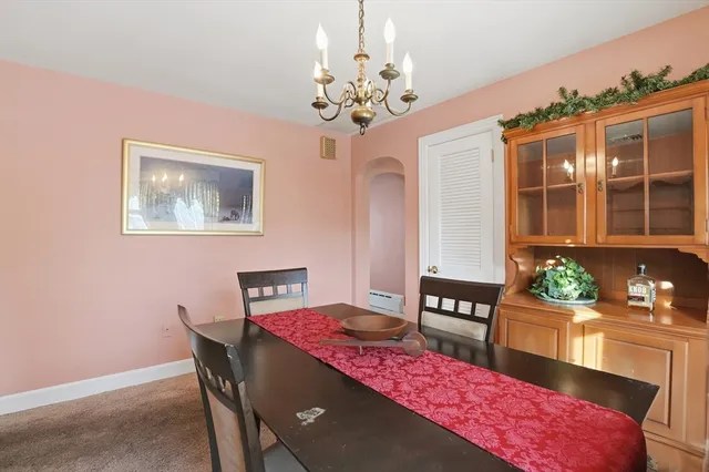 a view of a dining room with furniture and chandelier