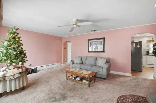a living room with furniture and flowers