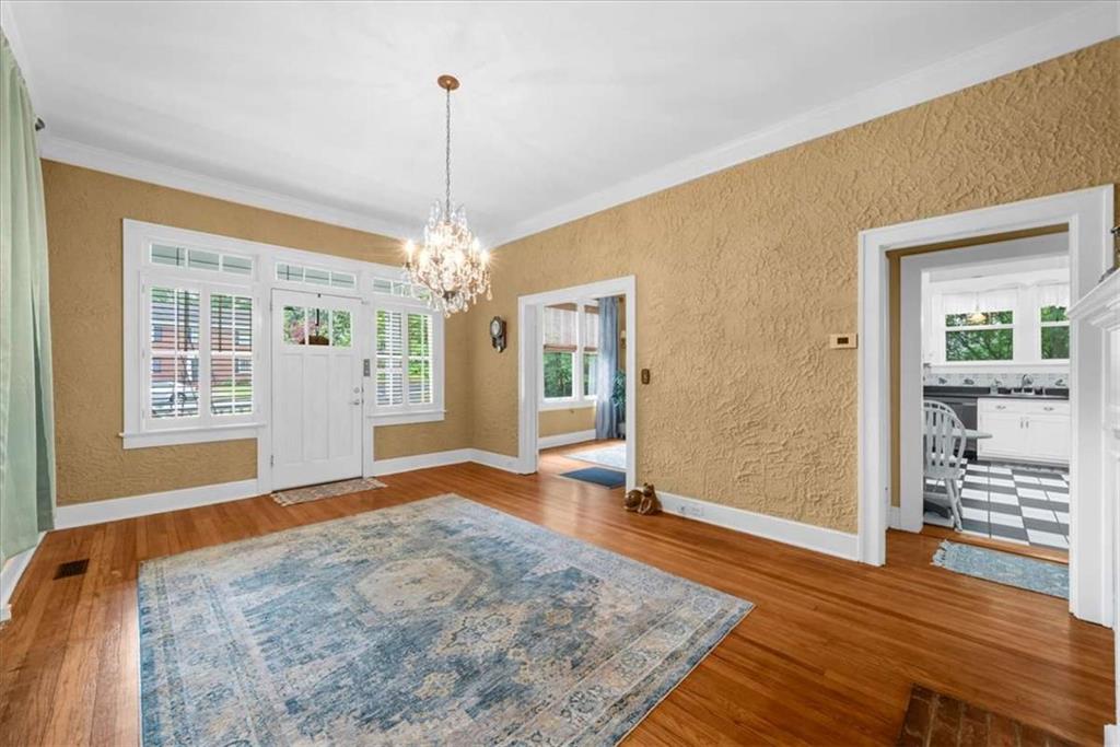 106 Westmore Road Southwest Rome, GA 30165 - Photo 7 of 56 a view of a livingroom with wooden floor and a chandelier