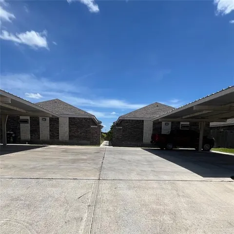 a view of the house with a yard