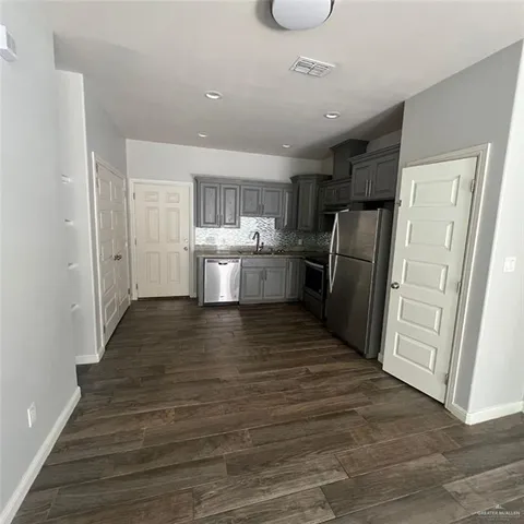 a kitchen with a refrigerator and a sink