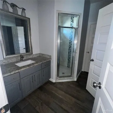 a bathroom with a granite countertop sink mirror and vanity