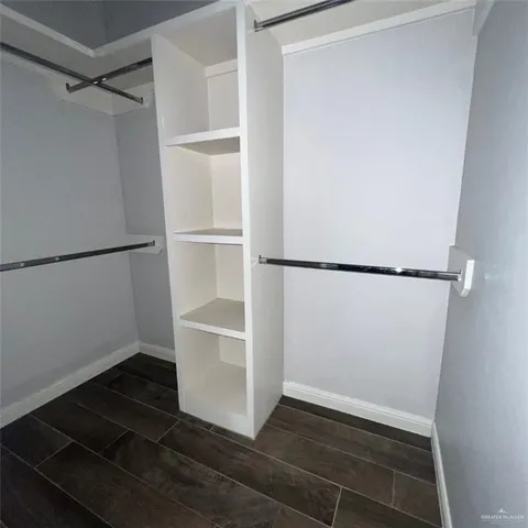 a view of walk in closet with empty racks
