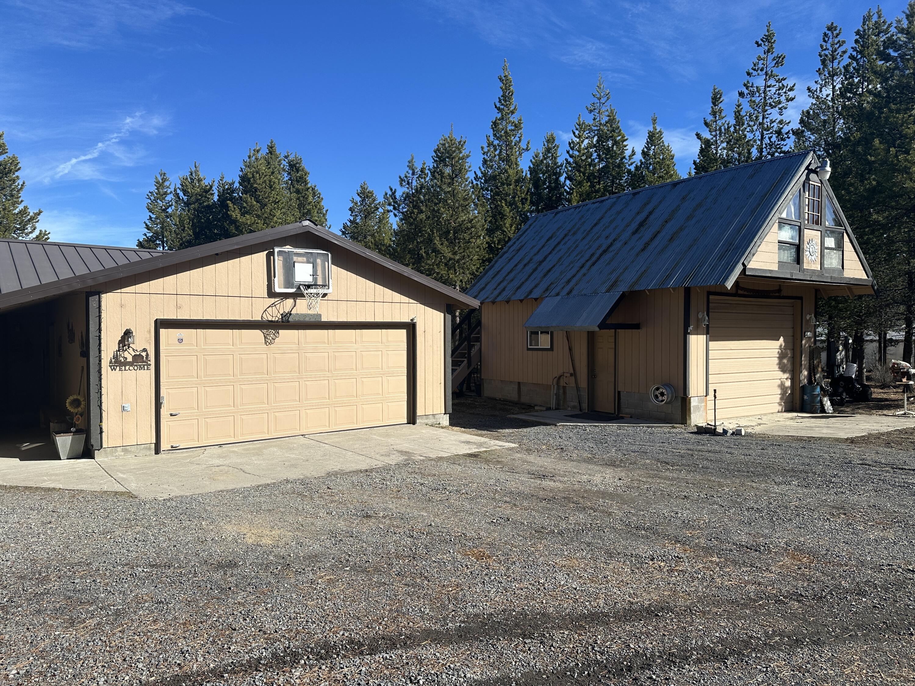 123977 Surveyor Road Crescent Lake, OR 97733 - Photo 2 of 41 a front view of a house with a yard and garage