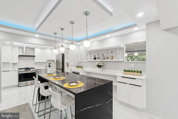a kitchen with a sink a stove and chairs