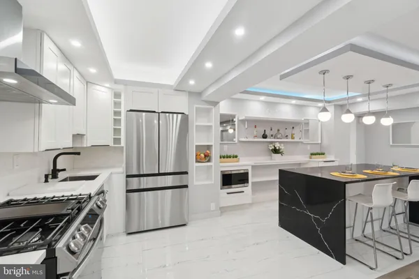 a kitchen with granite countertop a sink stainless steel appliances and cabinets