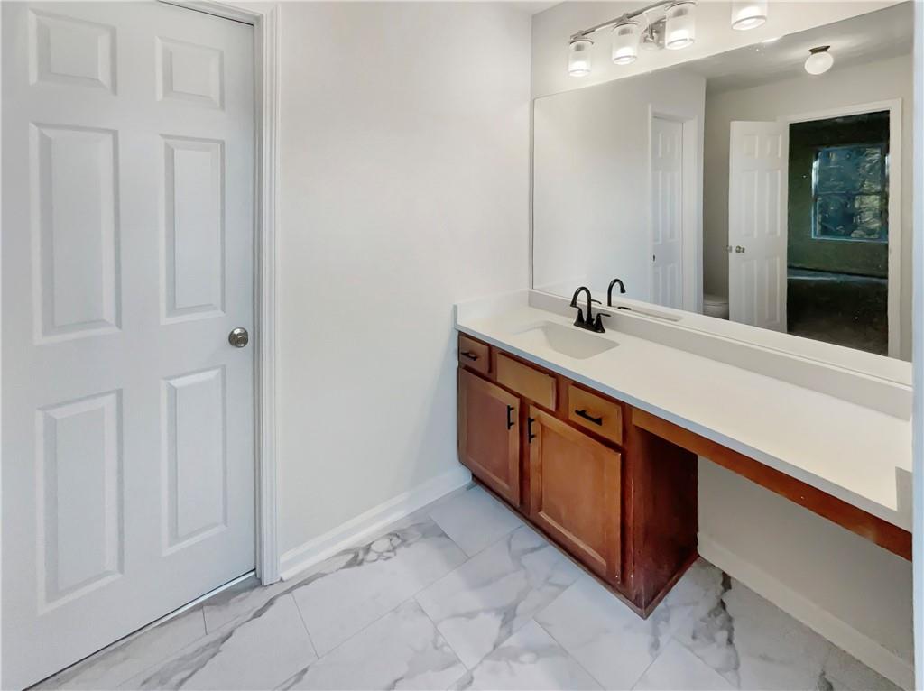 11569 Kades Trail Hampton, GA 30228 - Photo 19 of 25 a bathroom with a sink and a mirror