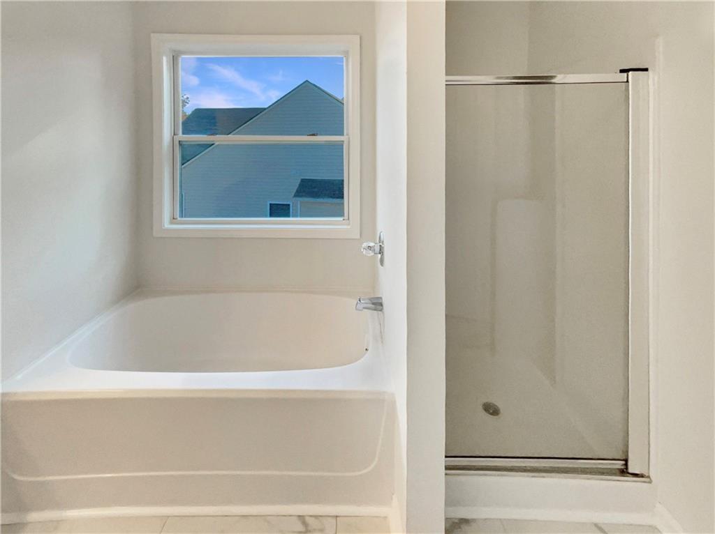 11569 Kades Trail Hampton, GA 30228 - Photo 20 of 25 a bathroom with a bathtub