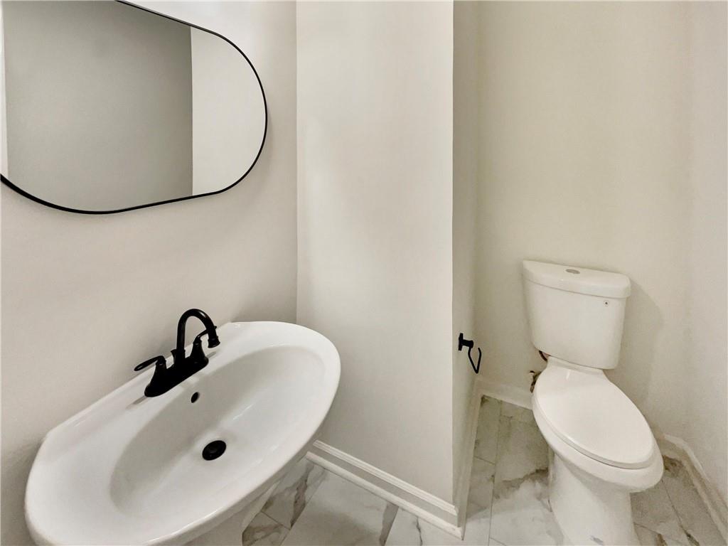 11569 Kades Trail Hampton, GA 30228 - Photo 21 of 25 a bathroom with a sink and a mirror