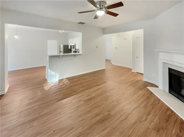 a view of a kitchen with a sink and a fireplace
