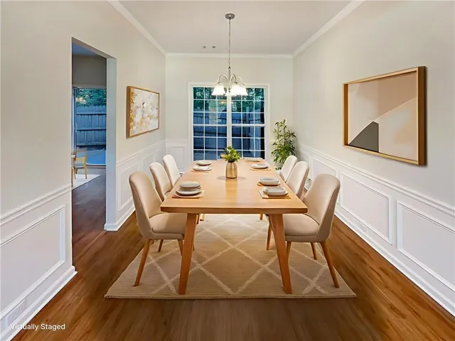 a dining room with wooden floor a chandelier a glass table and chairs