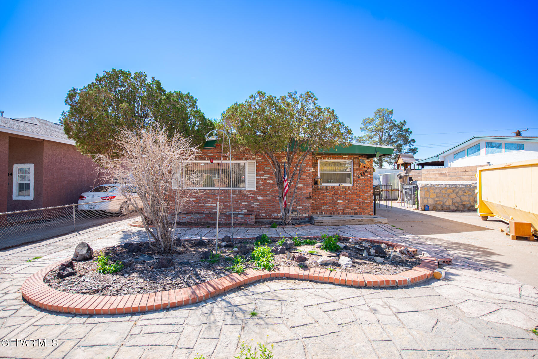 6240 Papago Road El Paso, TX 79905 - Photo 1 of 12 a front view of a house with a garden and yard