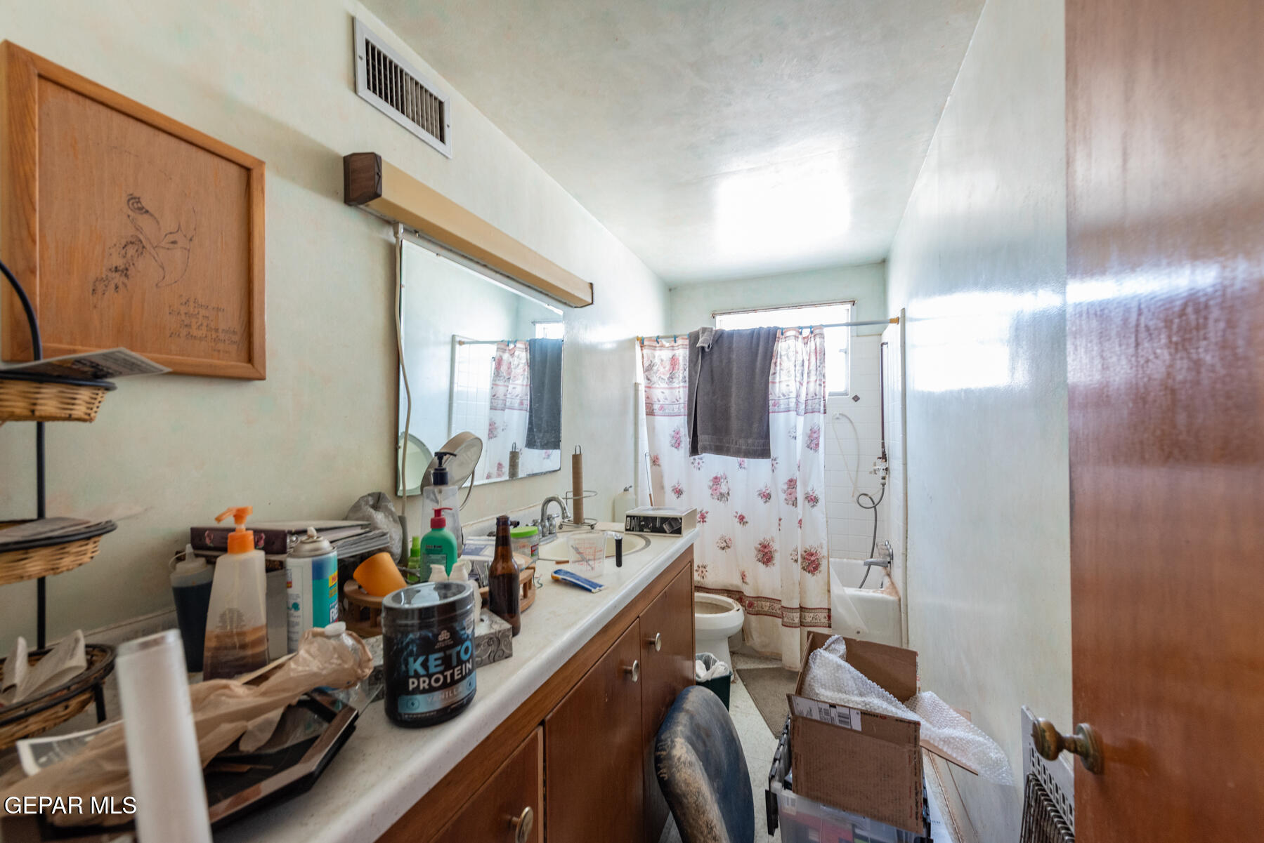 6240 Papago Road El Paso, TX 79905 - Photo 12 of 12 a view of a bathroom with sink mirror and shower