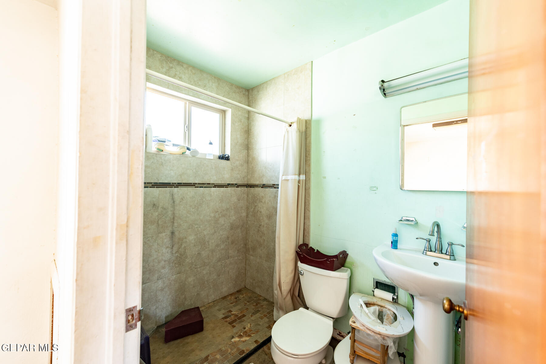 6240 Papago Road El Paso, TX 79905 - Photo 9 of 12 a white toilet sitting next to a bathroom sink
