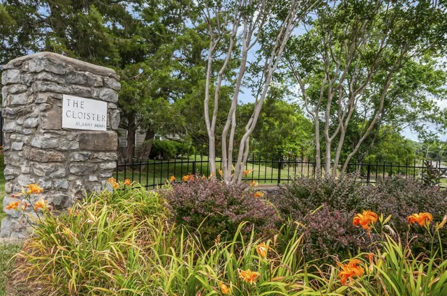 a view of street with lots of flowers and trees