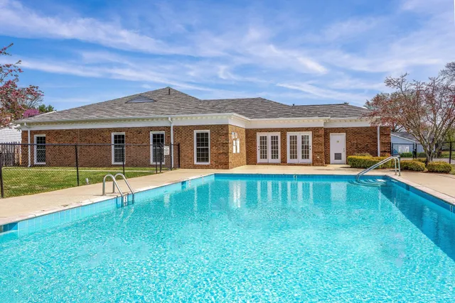 a view of a grassy field with trees in the background