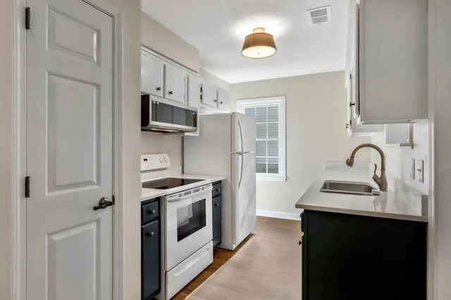 a kitchen with stainless steel appliances granite countertop a sink stove oven and refrigerator