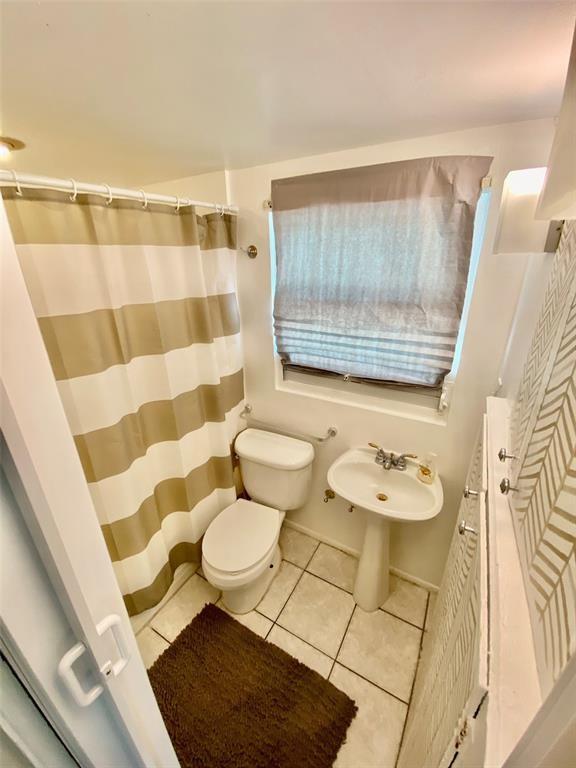 1310 Northeast 30th Street, Unit 4 Fort Lauderdale, FL 33334 - Photo 16 of 24 a bathroom with a sink toilet and shower