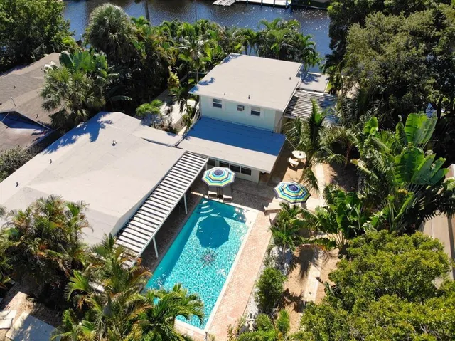 an aerial view of a house with a yard