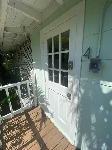 a view of balcony with wooden floor and seating space