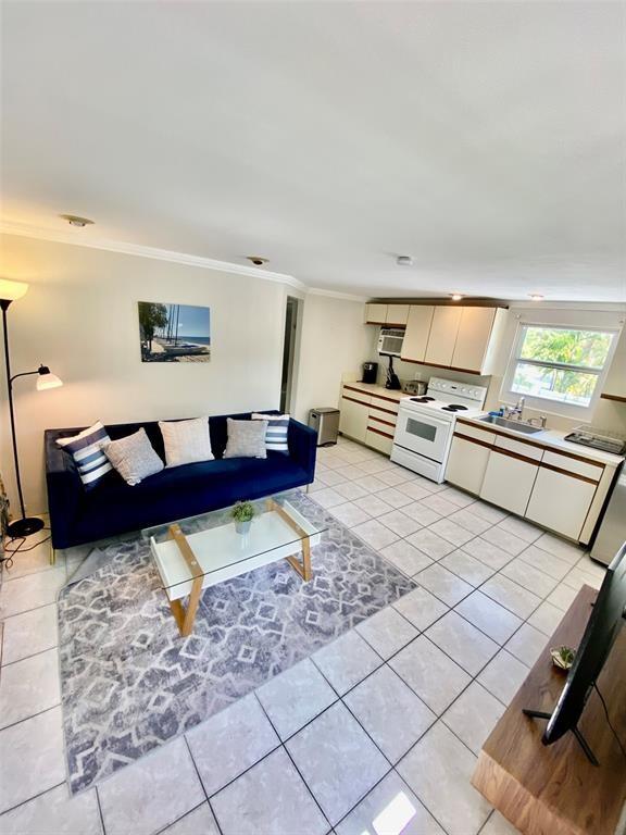 1310 Northeast 30th Street, Unit 4 Fort Lauderdale, FL 33334 - Photo 4 of 24 a living room with a couch and a coffee table