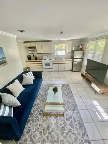 a living room with furniture and a rug