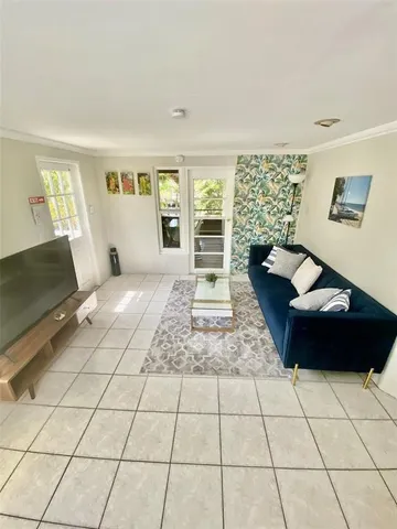 a bedroom with a bed and a couch next to a window