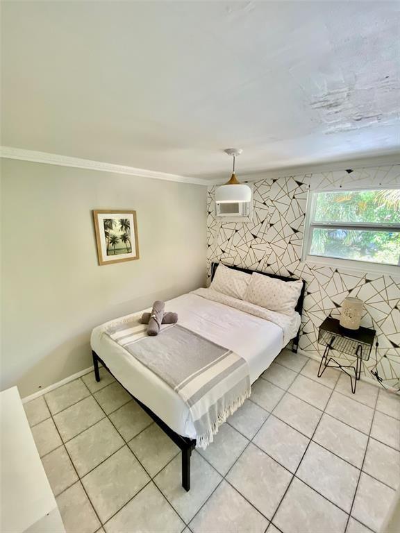 1310 Northeast 30th Street, Unit 4 Fort Lauderdale, FL 33334 - Photo 8 of 24 a bedroom with a bed and window