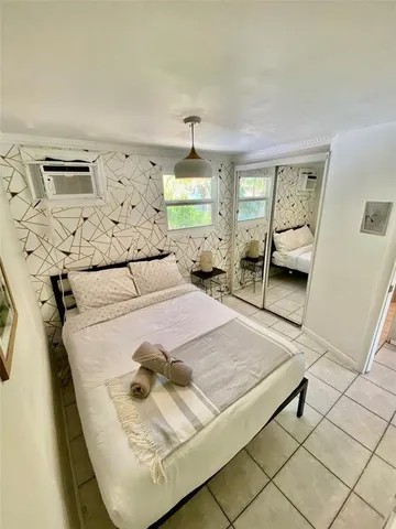 a bedroom with a bed and window